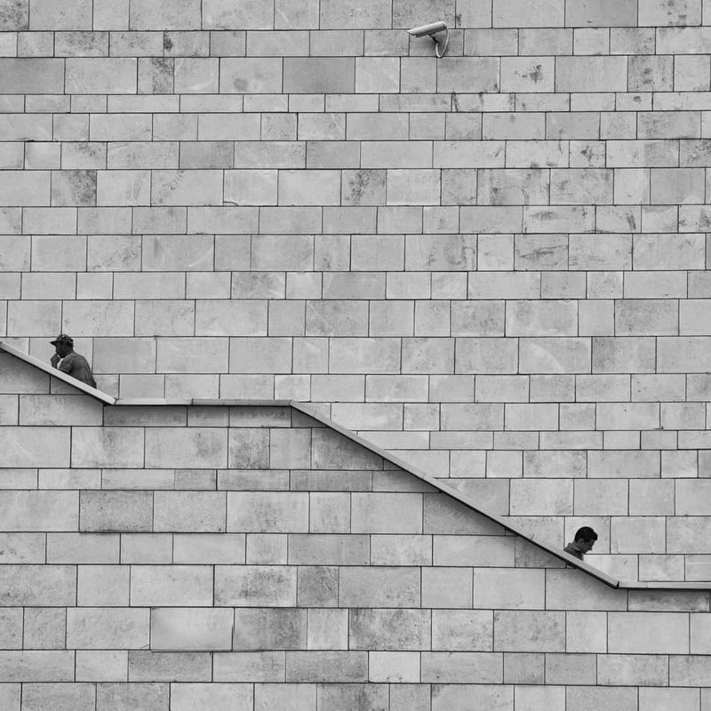 two man walking on some stairs