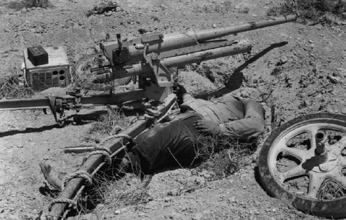 Antitanque M35 de 47 mm puesto fuera de combate. Junto a la pieza, se encuentra muerto uno de sus servidores